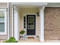 Inviting front entrance with a black door, sidelights, and decorative wreath, framed by white columns at 44409 Oriole Dr # 200, Indian Land, SC 29707