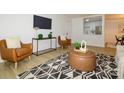 Well-lit living room with modern furniture and a view of the bright, clean, and updated kitchen at 4754 Hedgemore Dr # E, Charlotte, NC 28209