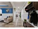 Hallway with wood flooring, wainscotting and blue accent wall leading to the dining room at 537 Lakeview Dr, McAdenville, NC 28101