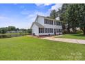 Picturesque two-story home on a lush lawn by the lake with mature trees at 6516 Laurel Springs Ct, Charlotte, NC 28227