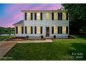Charming two-story home with classic shutters and manicured lawn overlooking the serene lake at 6516 Laurel Springs Ct, Charlotte, NC 28227