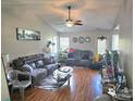 Inviting living room featuring hardwood floors, ceiling fan, and neutral color scheme, creating a cozy atmosphere at 6902 Vernon Wood Ln, Charlotte, NC 28262