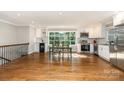 Bright, modern kitchen with stainless steel appliances, white cabinets, and an adjacent dining area with hardwood floors at 6935 Woodstock Dr, Charlotte, NC 28210