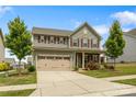 Inviting two-story home boasts a well-manicured lawn and an attached two-car garage at 7263 Waterwheel Sw St, Concord, NC 28025