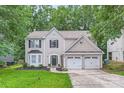 Beautiful two-story house with a well-maintained front lawn and attached two-car garage at 7810 Leisure Ln, Huntersville, NC 28078