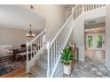 Inviting foyer showcasing elegant staircase and stylish flooring at 7810 Leisure Ln, Huntersville, NC 28078