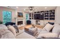 Cozy living room with a fireplace, built-in shelving, and comfortable seating at 7810 Leisure Ln, Huntersville, NC 28078