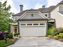 Charming exterior view of a home with a two-car garage and neatly trimmed landscaping at 8026 Greenview Terrace Ct, Charlotte, NC 28277