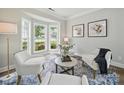Bright living room featuring bay window, hardwood floors, neutral paint and elegant decor at 8304 Prescott Glen Pkwy, Waxhaw, NC 28173