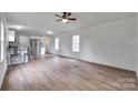 Bright living room showcases modern flooring, ceiling fan, and an open layout leading to the kitchen at 976 Neely Store Rd, Rock Hill, SC 29730
