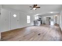 Open-concept living room featuring modern floors, ceiling fan and seamless flow into the bright kitchen at 976 Neely Store Rd, Rock Hill, SC 29730