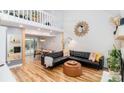 Open-concept living room with high ceilings, a fireplace, and hardwood floors at 10209 Green Tee Ln, Charlotte, NC 28277
