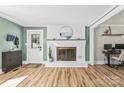 Bright living room with a white brick fireplace, hardwood floors, and neutral wall color at 1072 5Th Ne St, Hickory, NC 28601