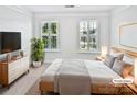 Calming and bright, this bedroom has simple staging and light neutral paint at 1090 Mclaren Dr, Belmont, NC 28012