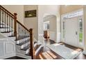 Elegant foyer with hardwood floors, staircase with iron spindles, and a view into adjacent rooms at 122 Ringneck Trl, Mooresville, NC 28117