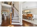 Spacious foyer featuring hardwood floors, stairs with wrought iron, and a dining room at 122 Ringneck Trl, Mooresville, NC 28117