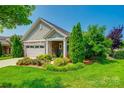 Beautiful home featuring manicured landscaping with vibrant plants and healthy green shrubs surrounding the residence at 1313 Haywood Park Rd, Marvin, NC 28173
