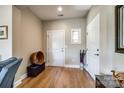 Welcoming foyer with hardwood floors, neutral paint, and natural light coming through a decorative window at 1313 Haywood Park Rd, Marvin, NC 28173