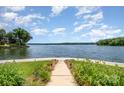 Scenic waterfront view featuring lush greenery and a tranquil expanse of water under a partly cloudy sky at 141 Badin Lake Cir, New London, NC 28127