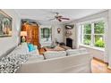 Bright living room with hardwood floors, fireplace, and large windows overlooking a lush backyard at 151 Cynthia St, Statesville, NC 28677