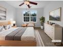 Cozy bedroom features ceiling fan, window view, and neutral décor at 1573 Maypine Commons Way, Rock Hill, SC 29732