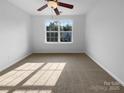 Neutral bedroom featuring a large window and plush carpet at 1573 Maypine Commons Way, Rock Hill, SC 29732