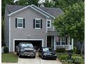 Beautiful two-story home featuring a covered porch, attached garage, and a well-manicured front yard at 1673 Beleek Ridge Ln, Clover, SC 29710