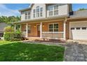 Welcoming front porch with brick accents and white railings offering curb appeal and a charming entrance at 176 Sharon Valley Dr, Hickory, NC 28601