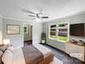 Cozy bedroom with neutral tones, three windows, and a ceiling fan at 2136 W 6Th Ave, Gastonia, NC 28052