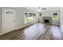 Inviting living room with hardwood floors, a fireplace, and ample natural light at 2136 W 6Th Ave, Gastonia, NC 28052