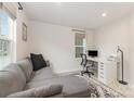 Cozy home office with gray sectional, desk, and natural light at 2203 Autumn Olive Ln, Stallings, NC 28104