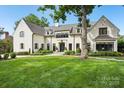 Charming white brick home with well-manicured lawn and stone walkway leading to the front door at 2215 Cortelyou Rd, Charlotte, NC 28211