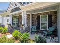 Inviting front porch with stone columns, comfortable seating, and stylish decor at 250 Winford Rd, Troutman, NC 28166