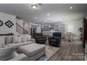 Open-concept living area with plush seating, modern finishes, and seamless access to the kitchen at 250 Winford Rd, Troutman, NC 28166