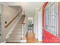 Inviting foyer with hardwood floors, staircase, and a glimpse into the dining area through the doorway at 2525 Saddlehorse Ln, Gastonia, NC 28056