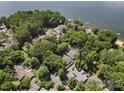 Aerial view showcases the home's location among lush trees and near the lake at 26 New River Trce, Lake Wylie, SC 29710