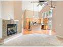 Open-concept living room featuring high ceilings, fireplace, and hardwood floors at 2695 Queens Rd, Lincolnton, NC 28092
