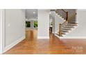 Inviting foyer with gleaming hardwood floors, open floor plan and a staircase with decorative metal spindles at 2857 Scarborough Ct, Gastonia, NC 28054