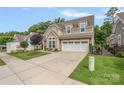 Charming two-story home featuring a spacious driveway and well-maintained landscaping at 3008 Laney Pond Rd, Matthews, NC 28104