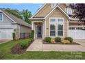 Inviting home entrance with a cozy porch and manicured garden at 3008 Laney Pond Rd, Matthews, NC 28104