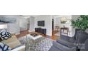 Comfortable living room with stylish furnishings, neutral decor, and hardwood floors throughout the home at 3800 Lovett Cir, Charlotte, NC 28210