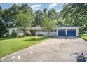 Traditional-style home with blue accents, an attached two-car garage, and a long driveway at 409 Edgewood Ct, Lancaster, SC 29720