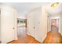 Hallway featuring hardwood floors, neutral paint and views into adjoining rooms at 409 Edgewood Ct, Lancaster, SC 29720