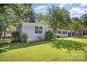 View of a detached structure on a well maintained lot with mature trees at 409 Edgewood Ct, Lancaster, SC 29720
