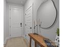 Bright entryway featuring a round mirror, a sleek wooden console table, and neutral-toned walls at 5006 Tiny Ln, Charlotte, NC 28203