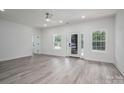 Bright living room featuring fresh paint, new flooring, and a stylish ceiling fan at 520 E Main St, Dallas, NC 28034