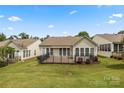 A home's back exterior boasts a large deck and fenced yard, ideal for outdoor enjoyment and entertaining at 56119 Finches Ct, Indian Land, SC 29707