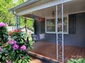 Inviting front porch with tile flooring and comfortable porch swing perfect for relaxing outdoors at 848 Woodland Rd, Statesville, NC 28677