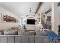 Cozy living room featuring exposed wooden beams, recessed lighting, and a large sectional sofa at 932 Shady Bluff Dr, Charlotte, NC 28211