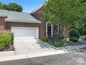 Charming brick home with a two-car garage, manicured lawn, and inviting curb appeal at 9451 Bonnie Briar Cir, Charlotte, NC 28277